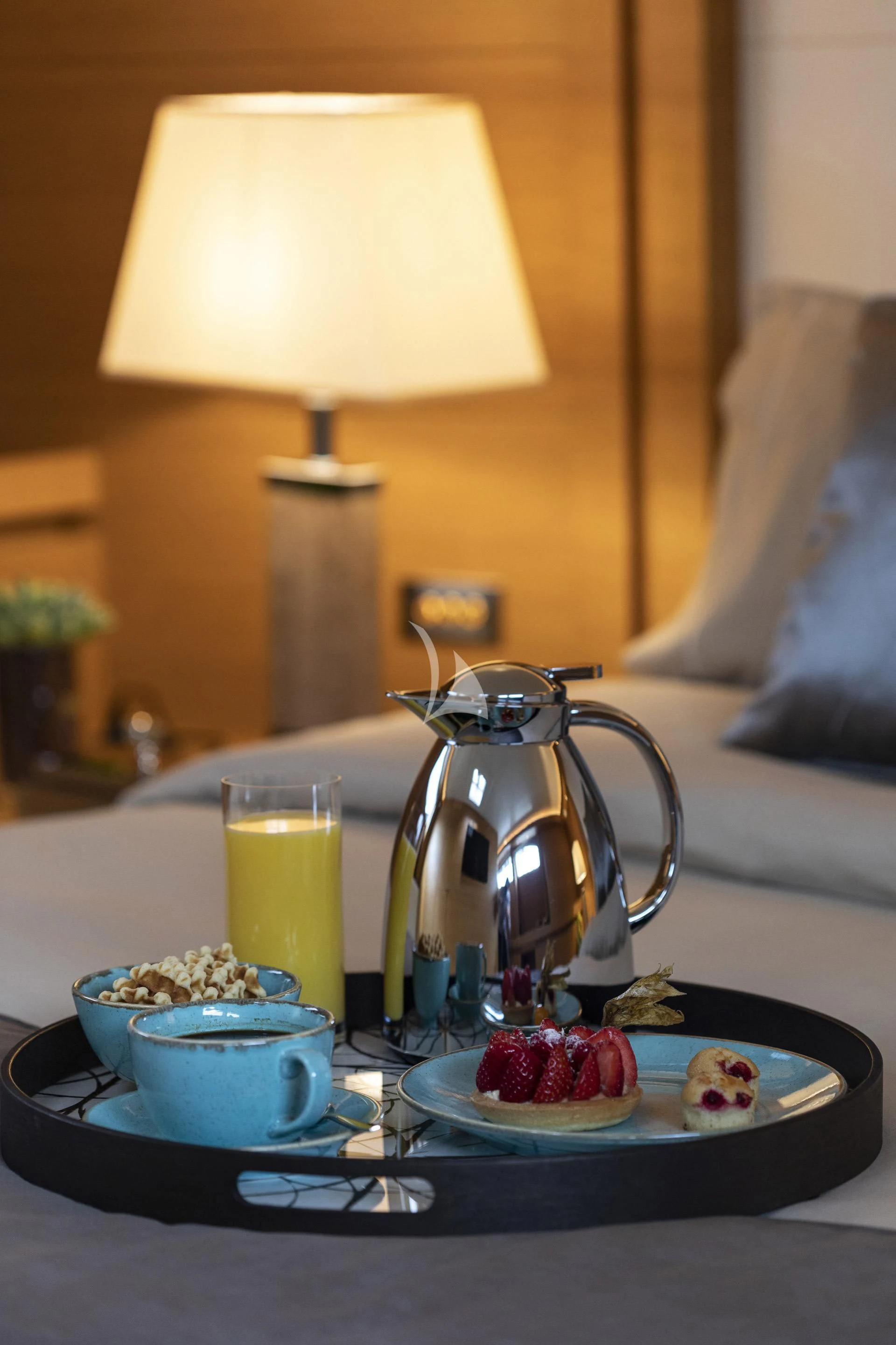 a table with a tea kettle and a plate of food on it aboard SANSARA Yacht for Sale