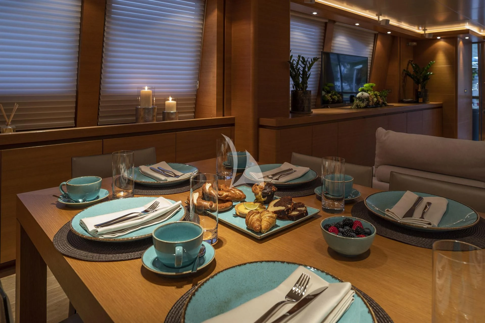 a table with plates and glasses aboard SANSARA Yacht for Sale
