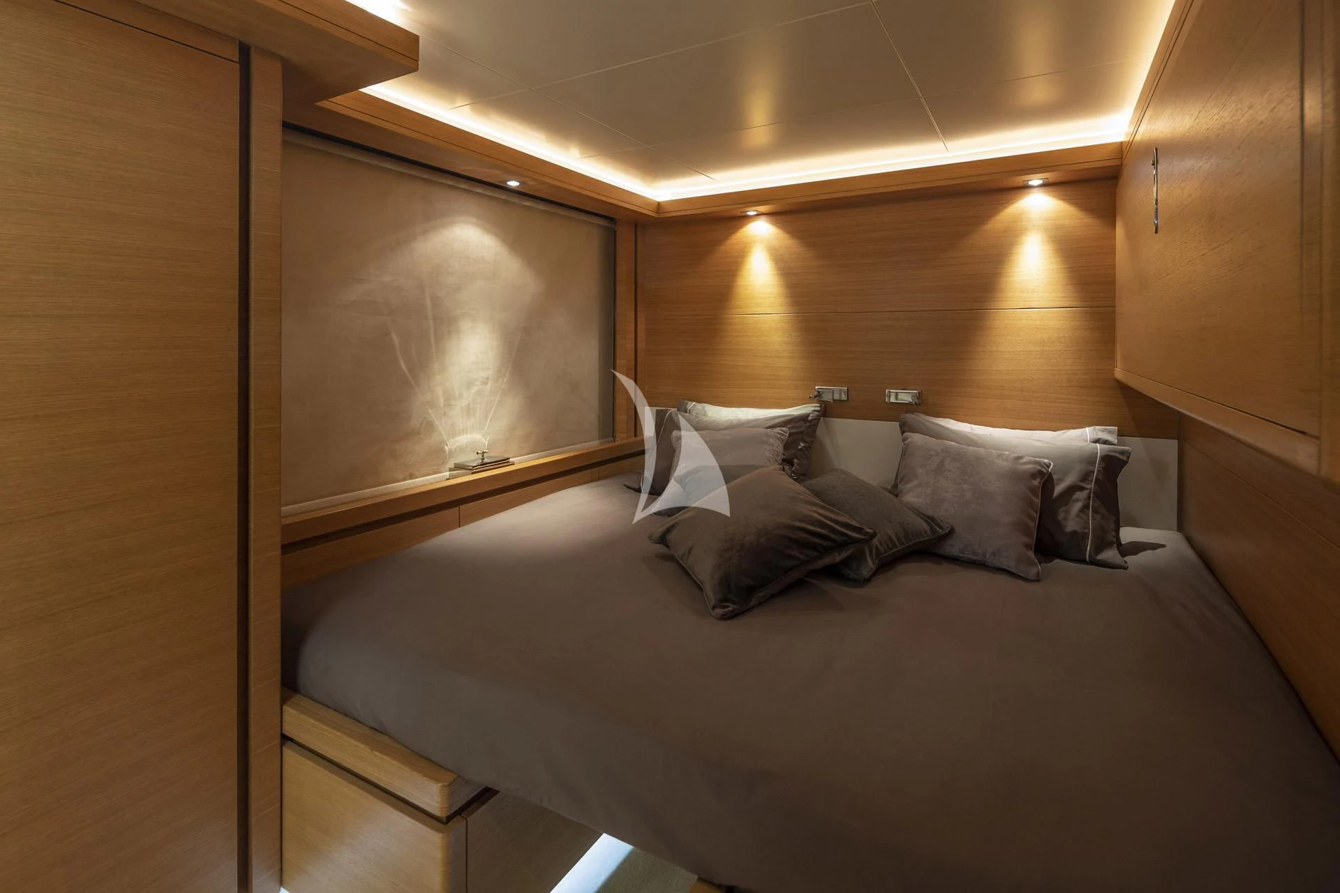 a bed with a black headboard aboard SANSARA Yacht for Sale