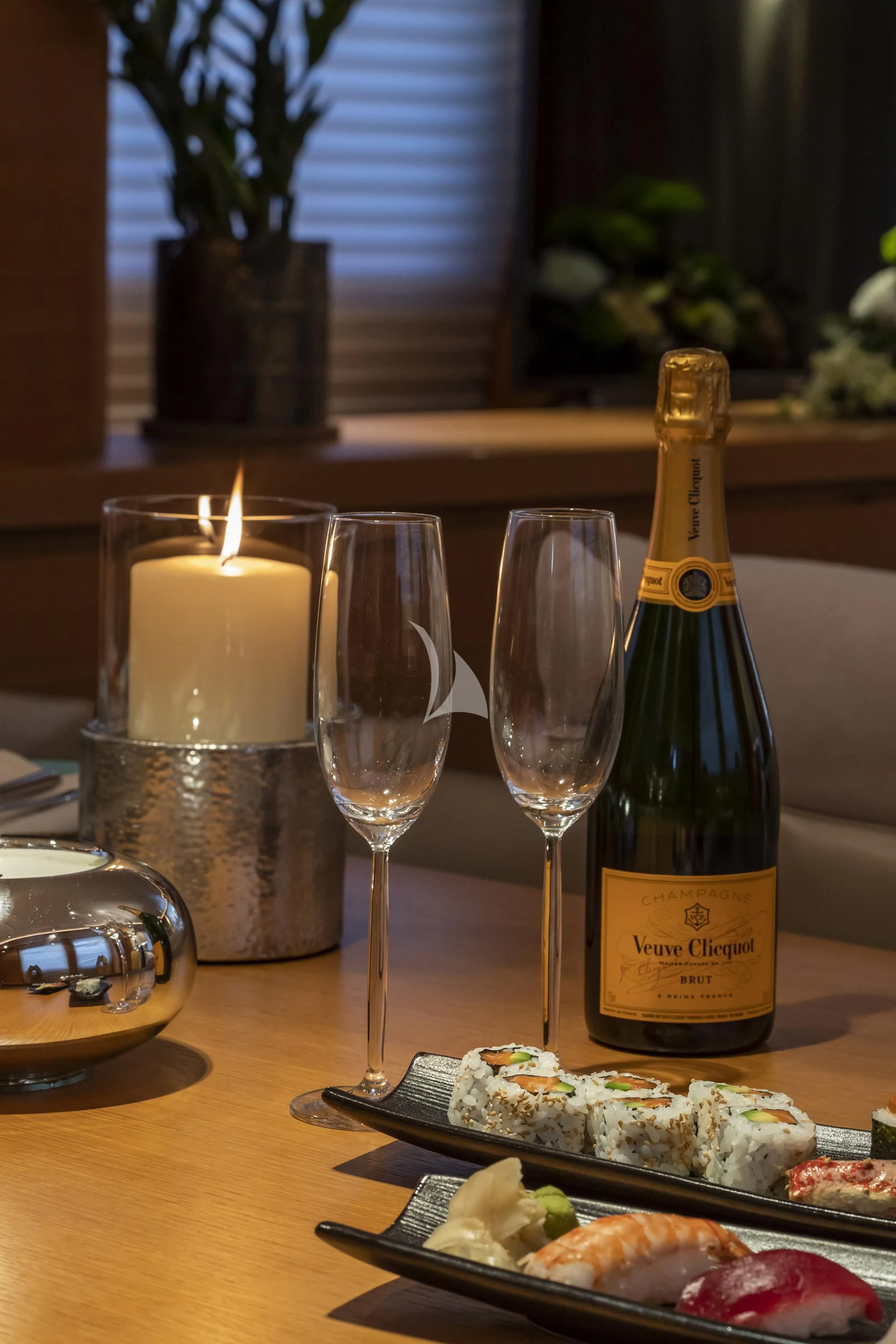 a bottle of wine next to a glass of wine aboard SANSARA Yacht for Sale
