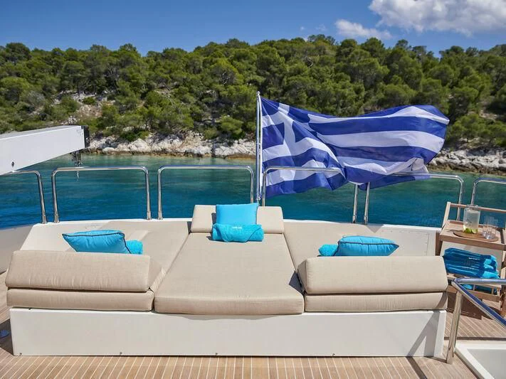 lounge chairs and umbrellas on a beach aboard SANSARA Yacht for Sale
