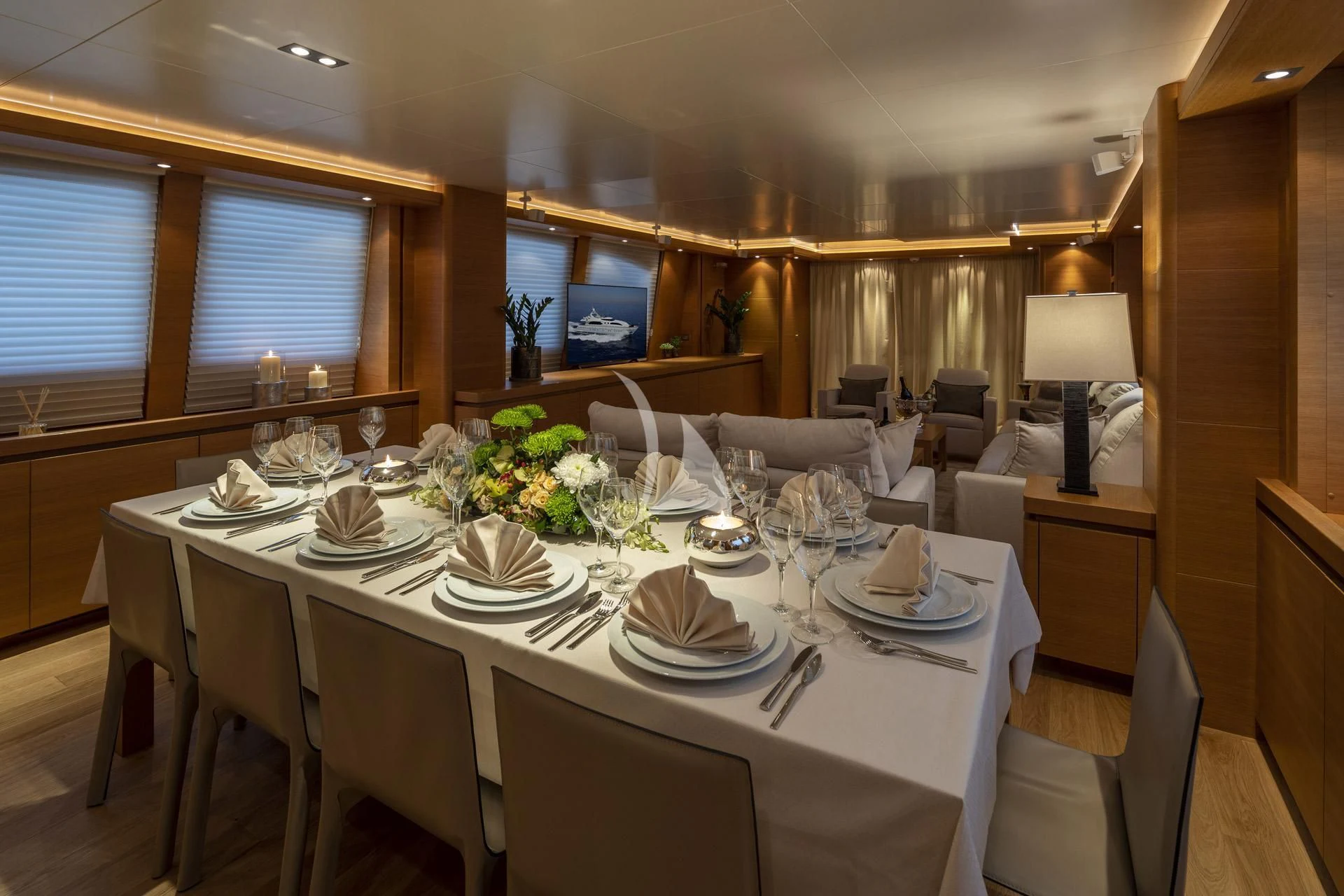 a dining room with a table set for a dinner aboard SANSARA Yacht for Sale