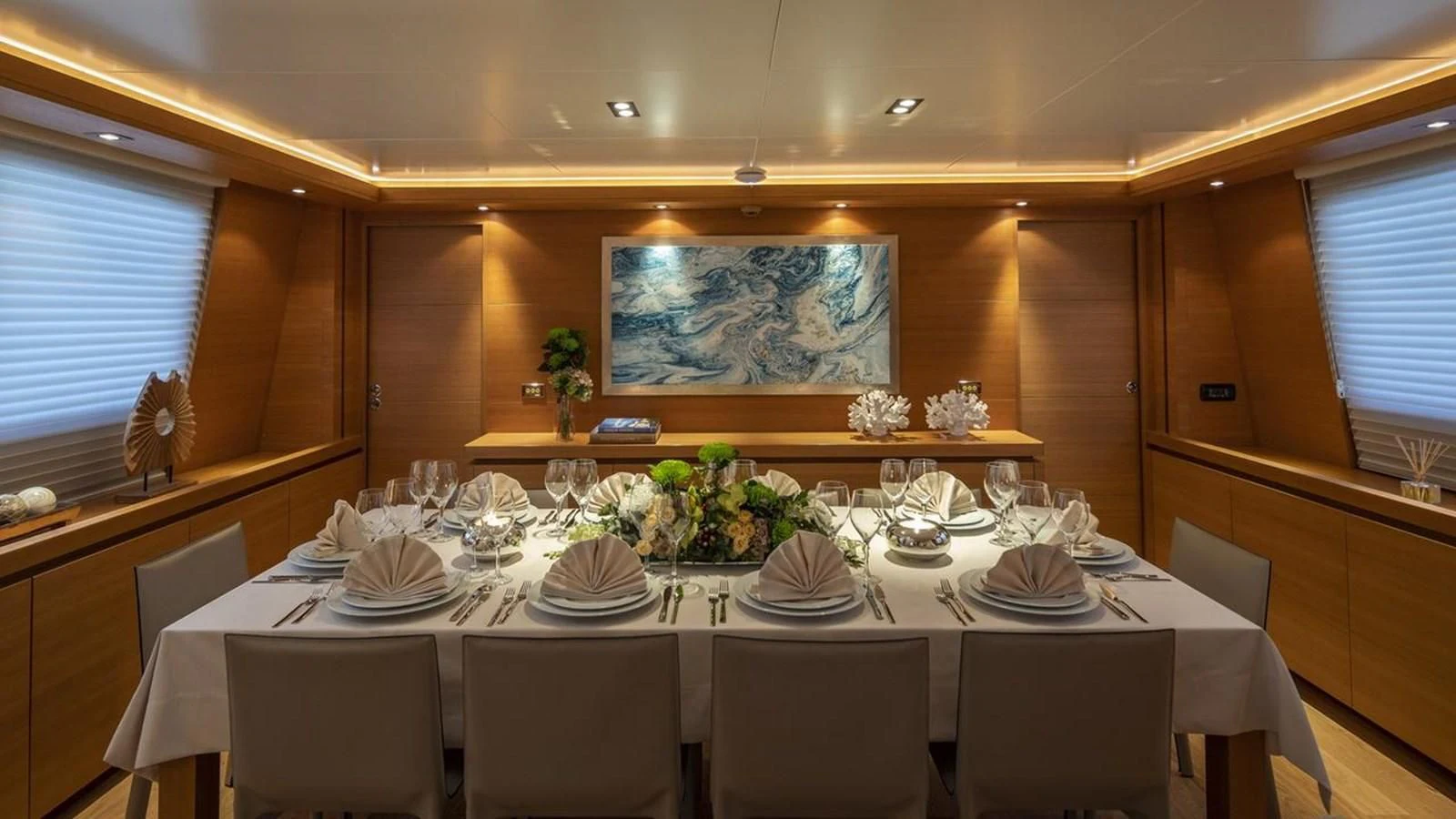 a dining room with a table set for a dinner aboard SANSARA Yacht for Sale