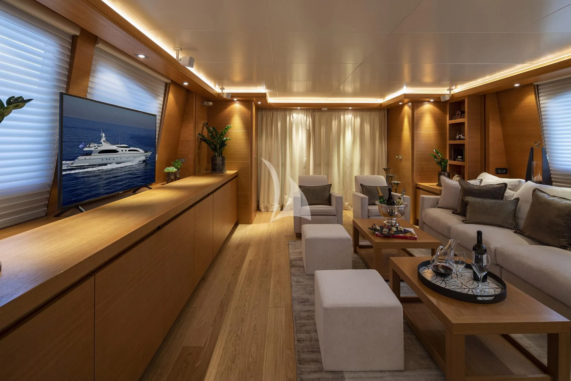 a living room with a large screen aboard SANSARA Yacht for Sale