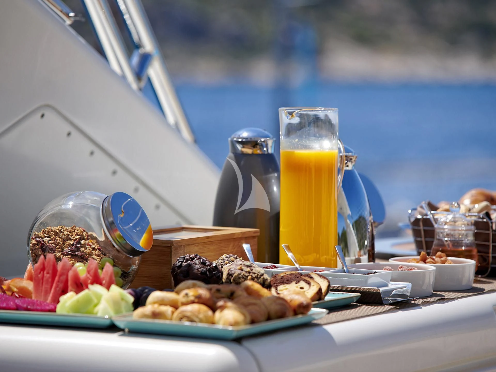 a table with food and drinks aboard SANSARA Yacht for Sale