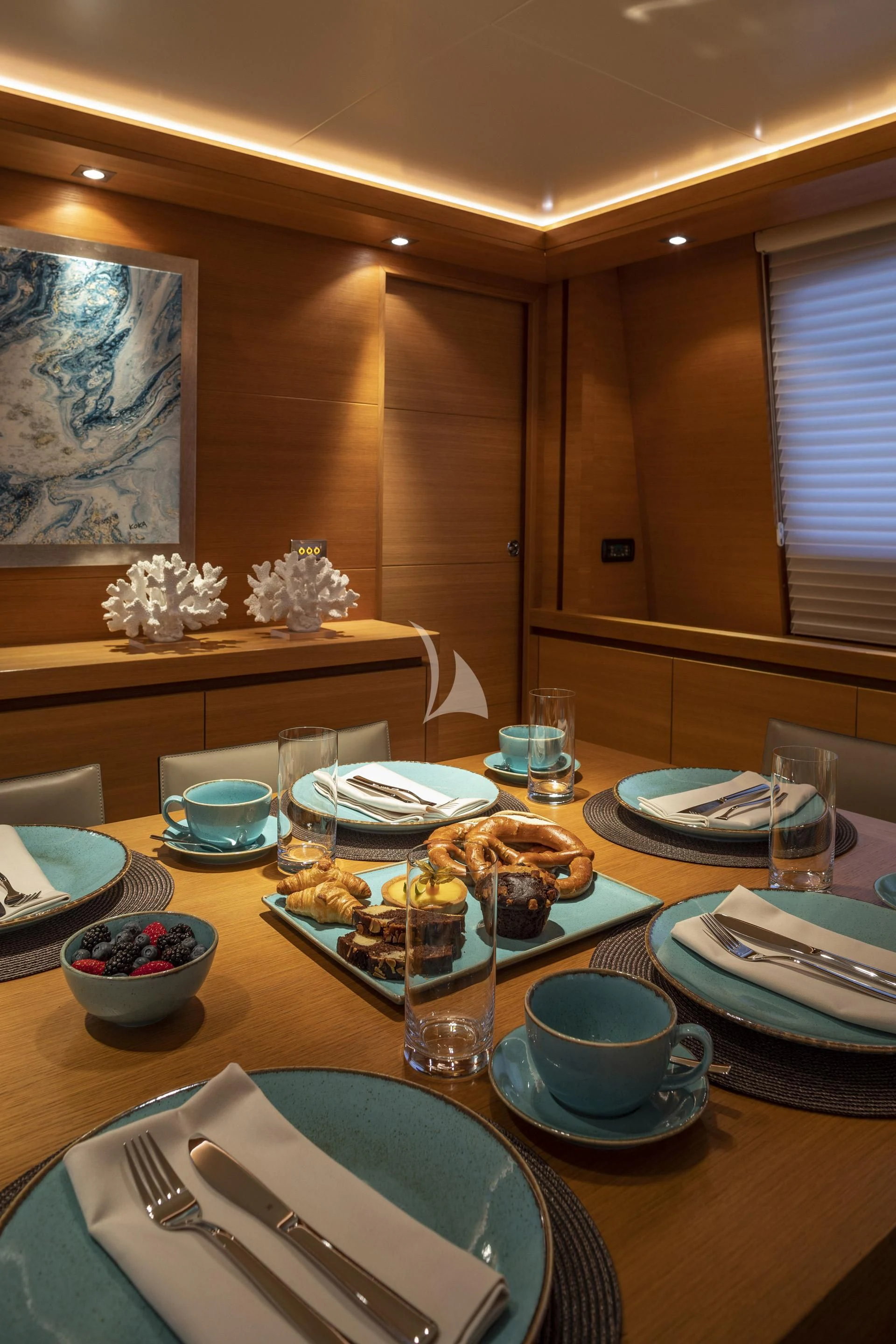 a table with plates and glasses aboard SANSARA Yacht for Sale