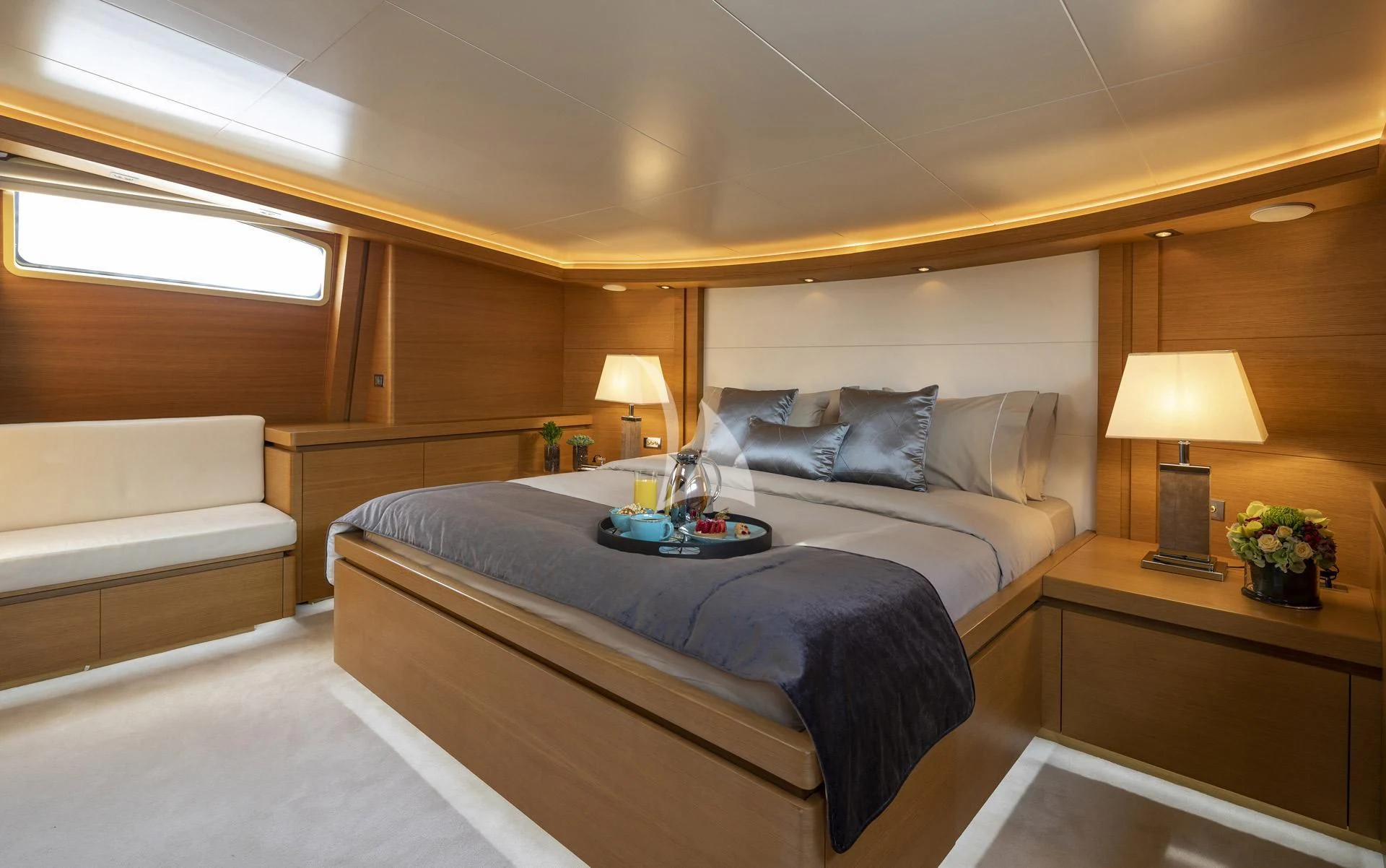 a bedroom with a bed and a lamp aboard SANSARA Yacht for Sale