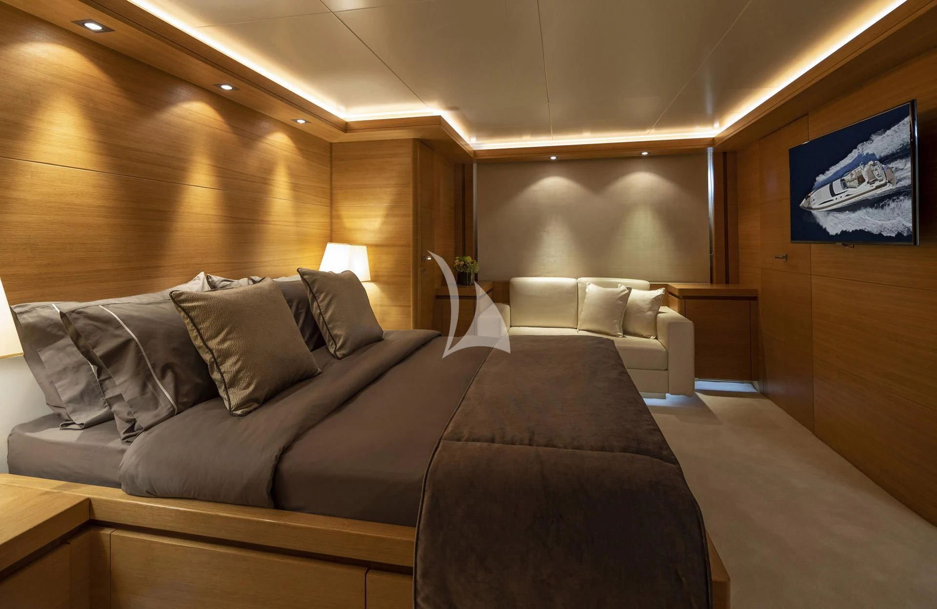 a room with a couch and a tv on the wall aboard SANSARA Yacht for Sale
