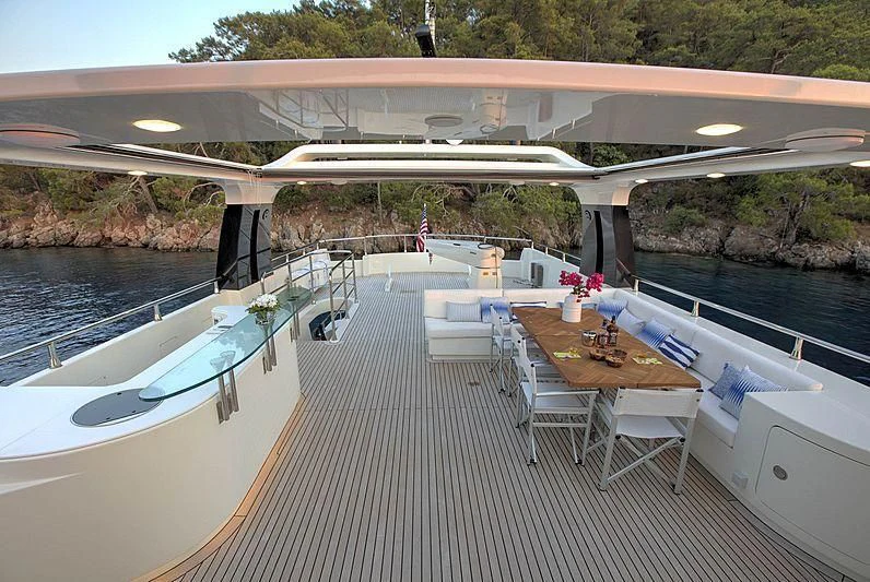 a patio with a table and chairs on it aboard ARCHSEA Yacht for Sale