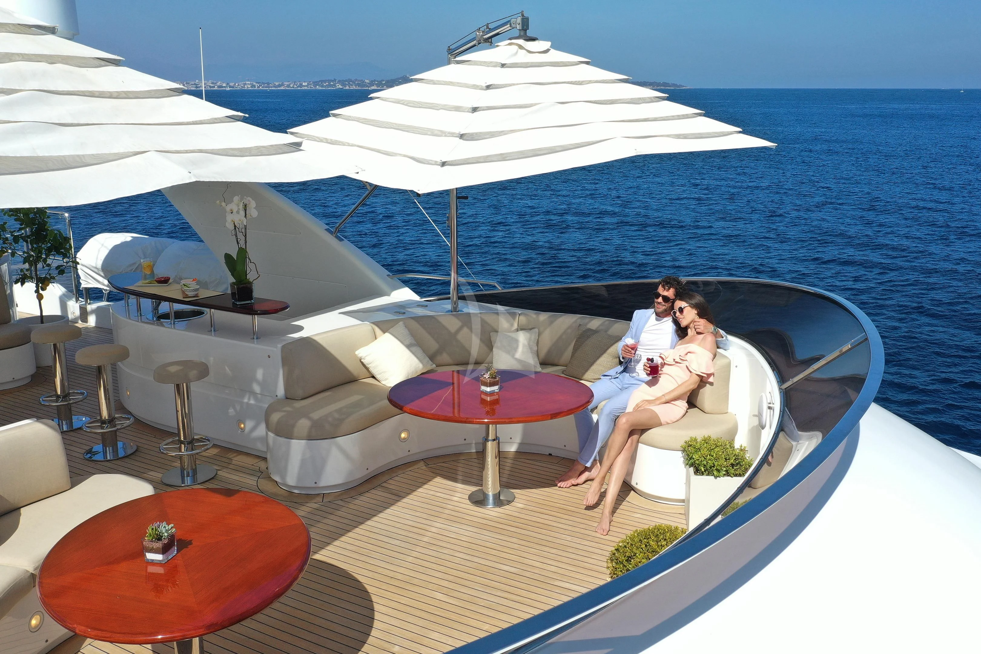 a couple sitting under an umbrella aboard MI AMORE JULIA Yacht for Sale