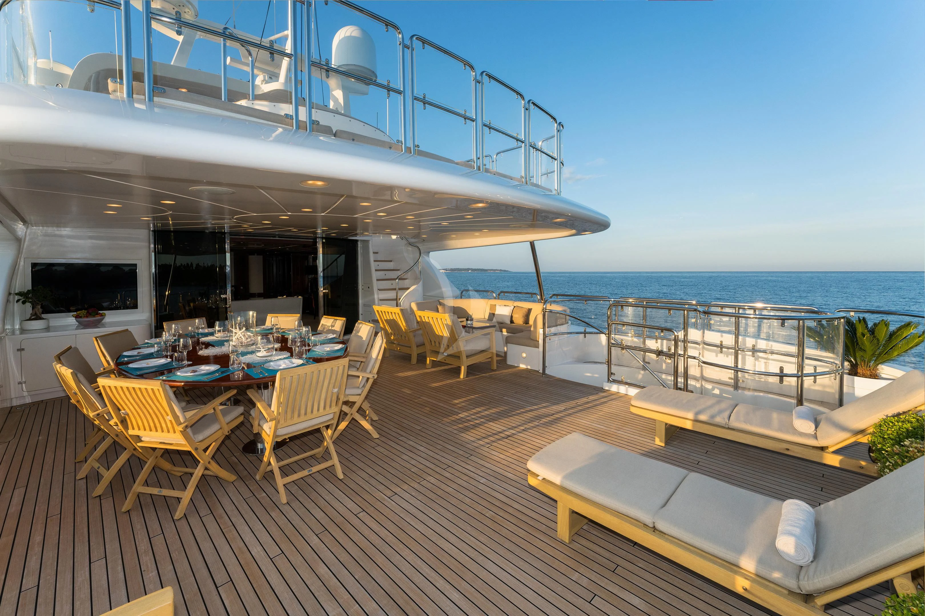 a deck with tables and chairs aboard MI AMORE JULIA Yacht for Sale