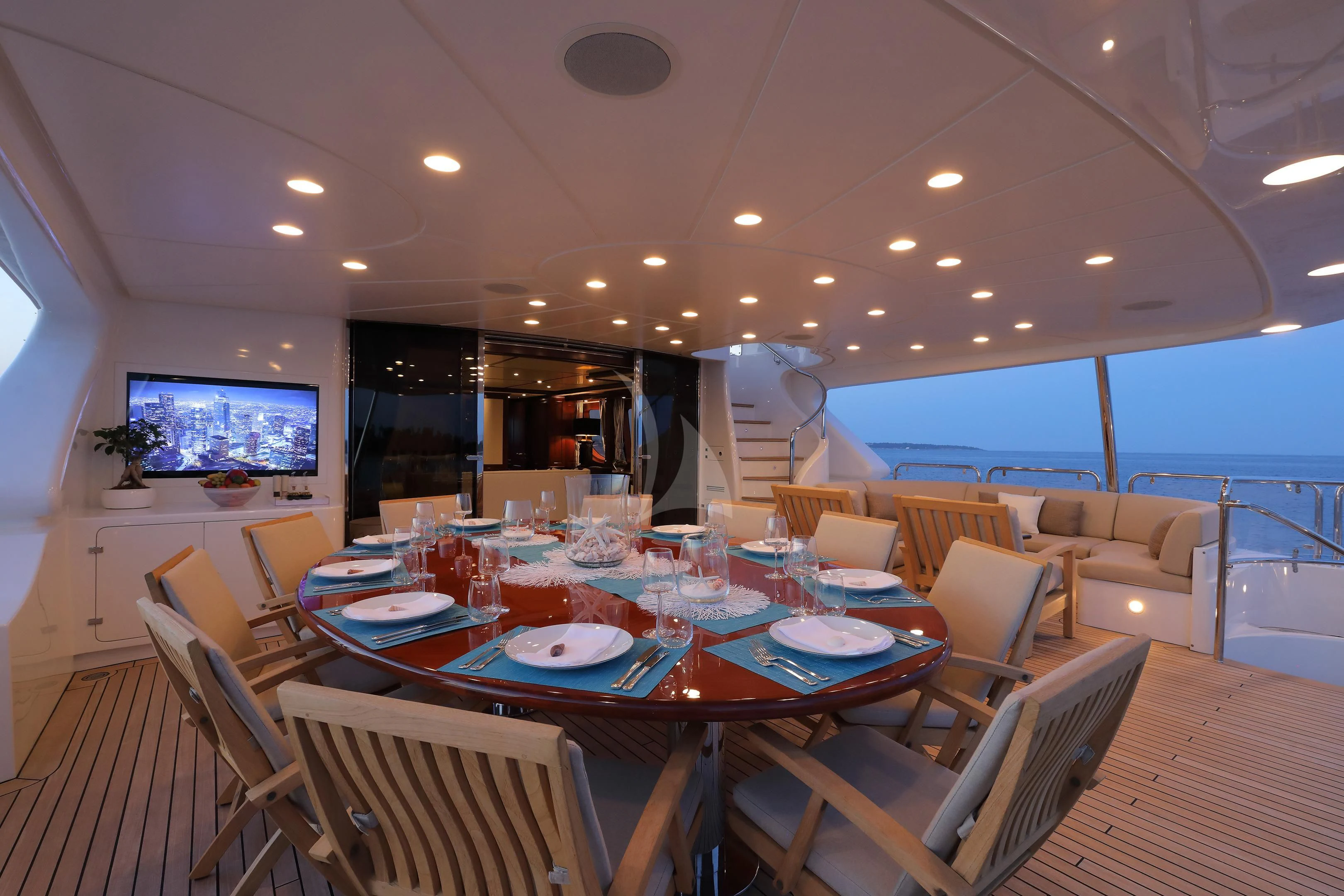 a dining room with a table set for a dinner aboard MI AMORE JULIA Yacht for Sale