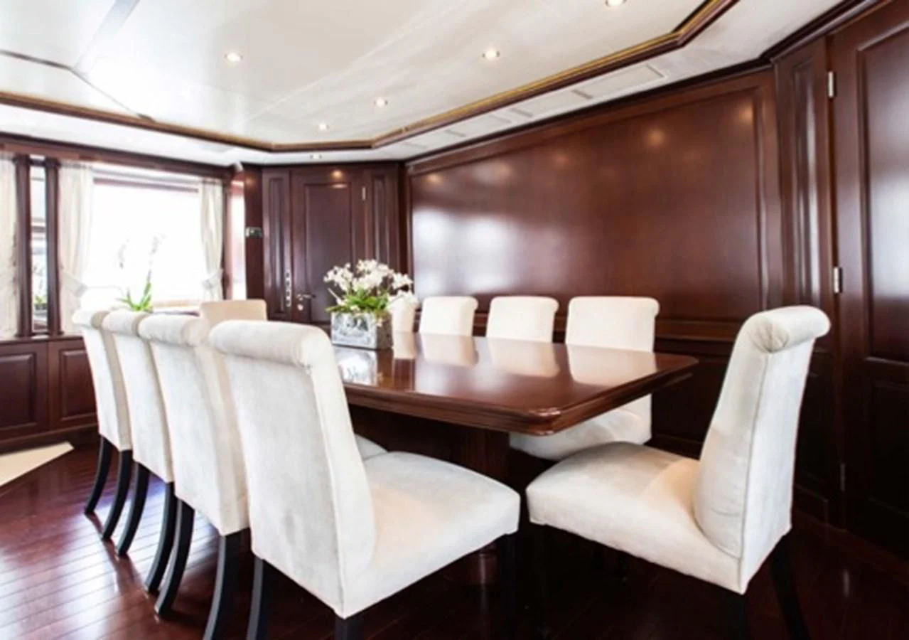 a dining room with white chairs aboard MI AMORE JULIA Yacht for Sale