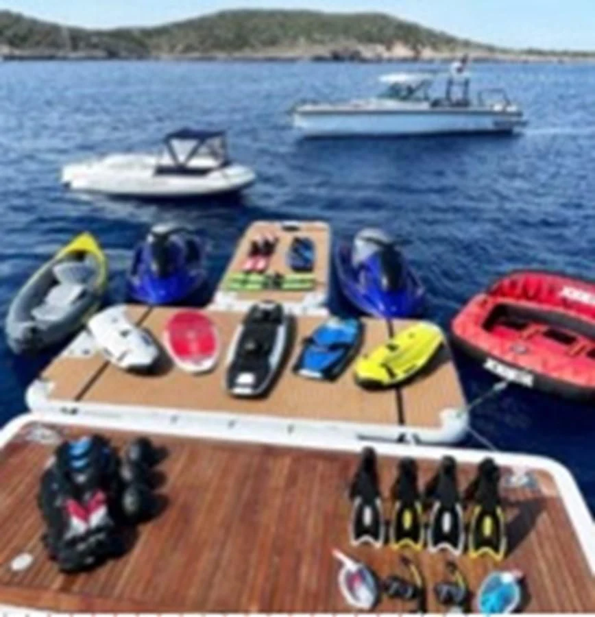 a table with a laptop and other objects on it aboard MI AMORE JULIA Yacht for Sale
