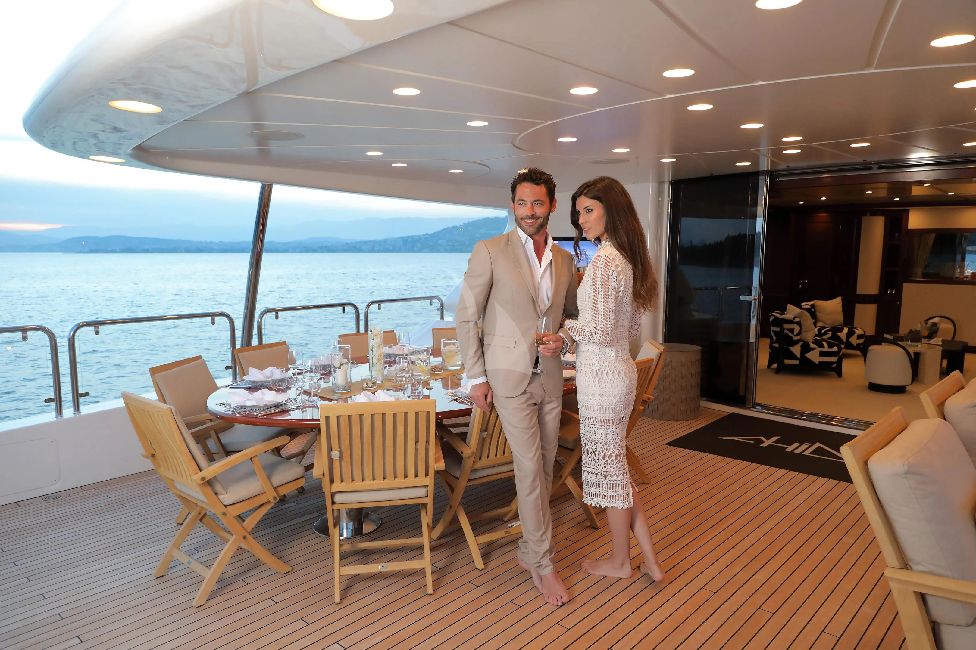 a man and woman standing on a deck overlooking a body of water aboard MI AMORE JULIA Yacht for Sale