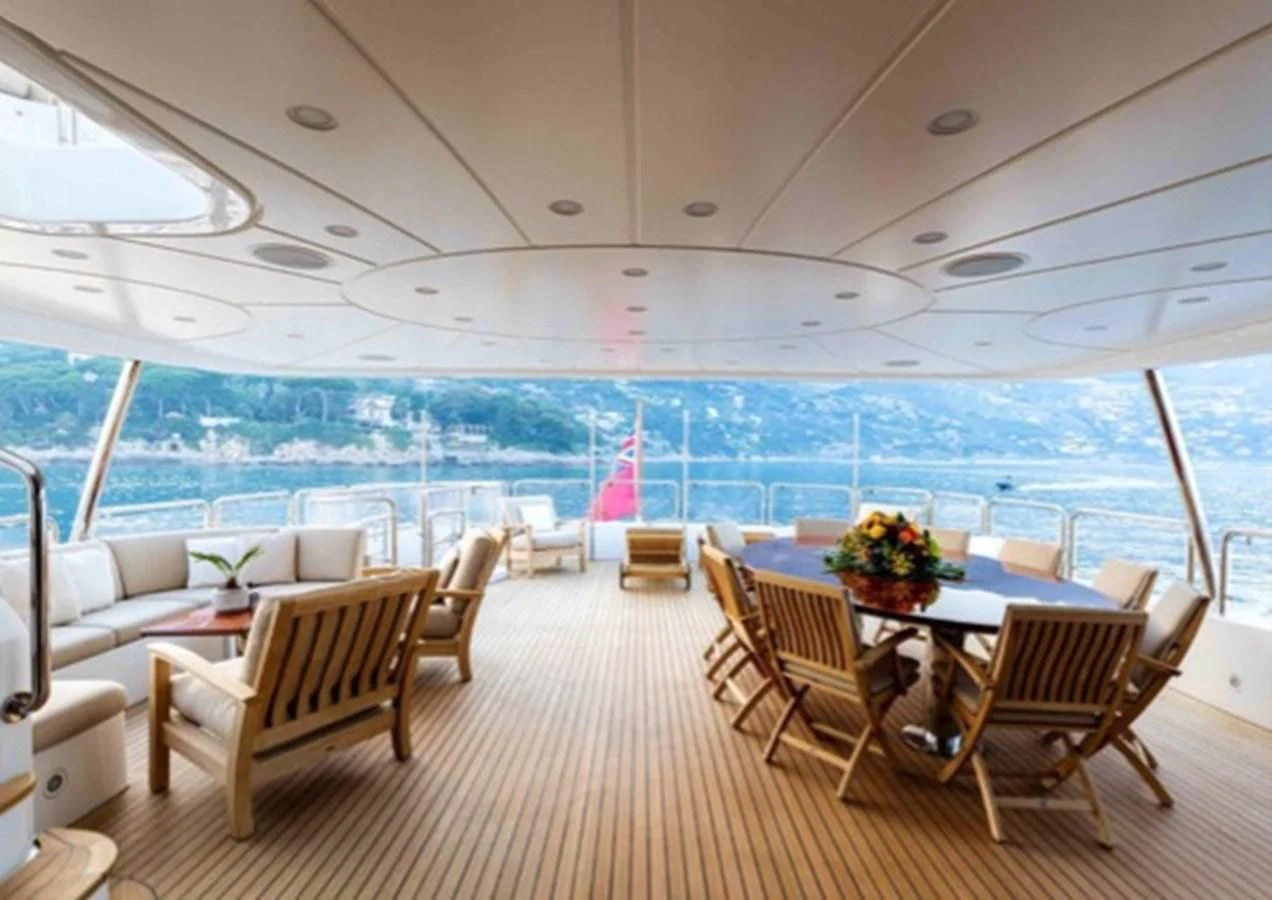a room with a table chairs and a view of the water aboard MI AMORE JULIA Yacht for Sale