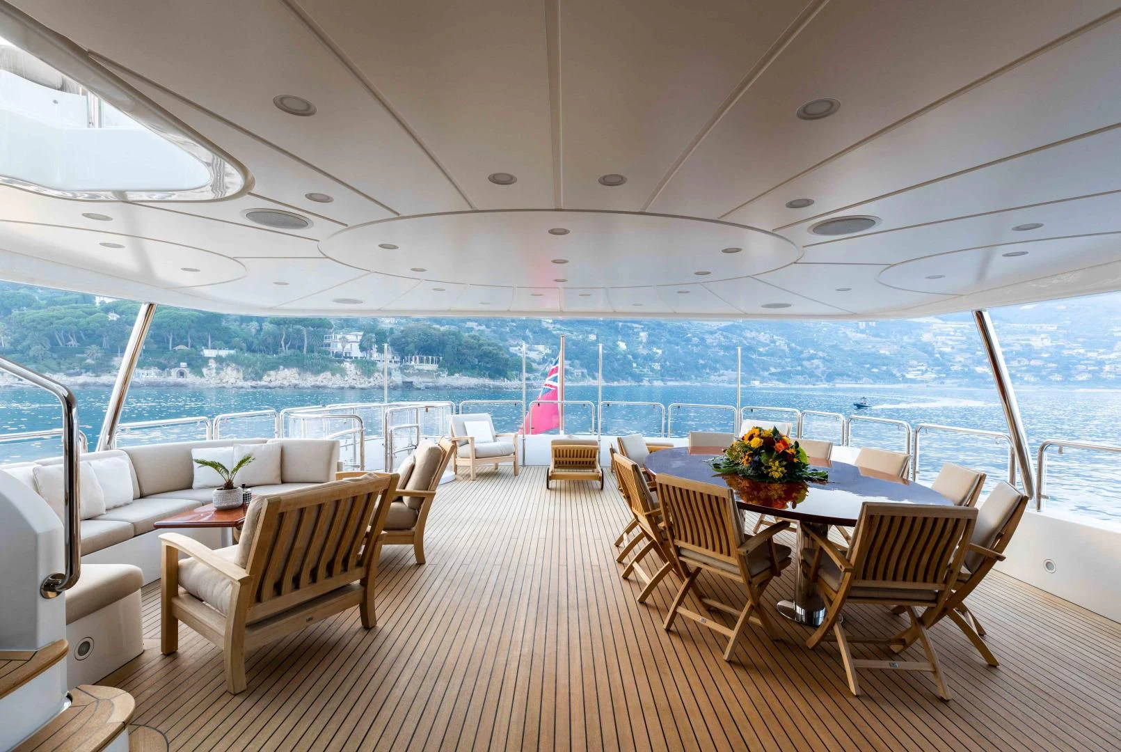 a large room with a table and chairs and a view of the ocean aboard MI AMORE JULIA Yacht for Sale