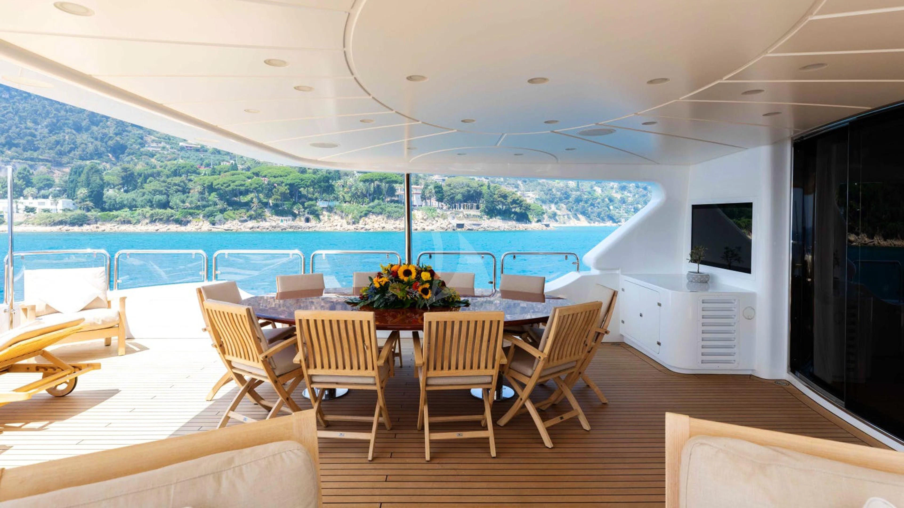a room with a table chairs and a tv on the wall aboard MI AMORE JULIA Yacht for Sale