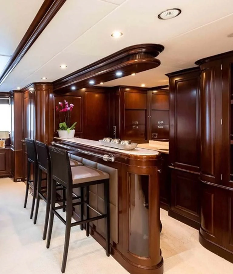 a kitchen with a bar and chairs aboard MI AMORE JULIA Yacht for Sale