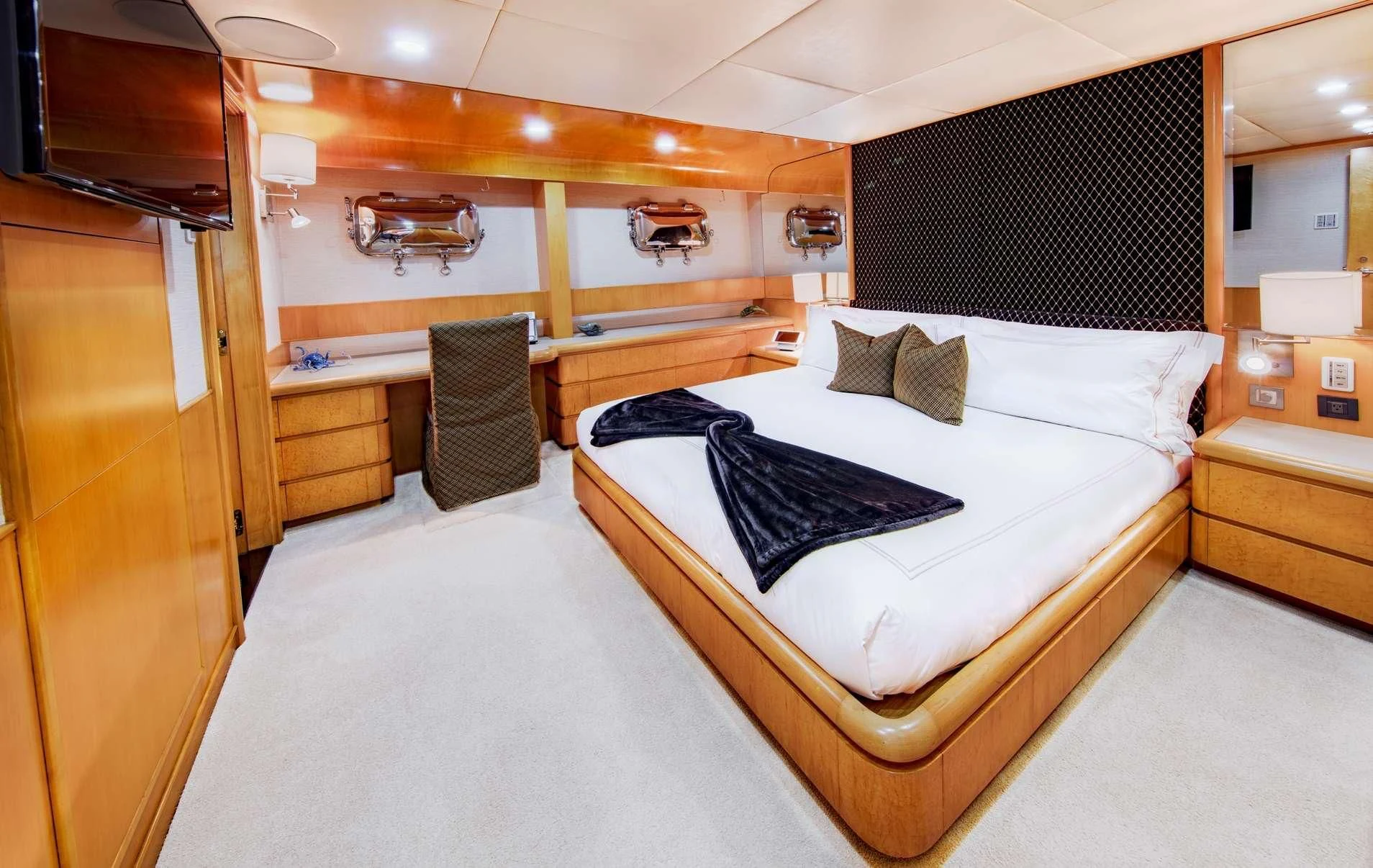a room with a bed and a chair aboard ISLAND HEIRESS Yacht for Charter