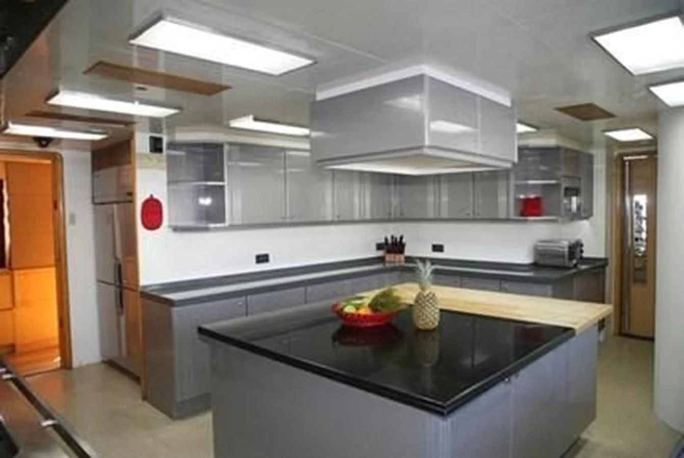 a kitchen with a black countertop aboard ISLAND HEIRESS Yacht for Charter