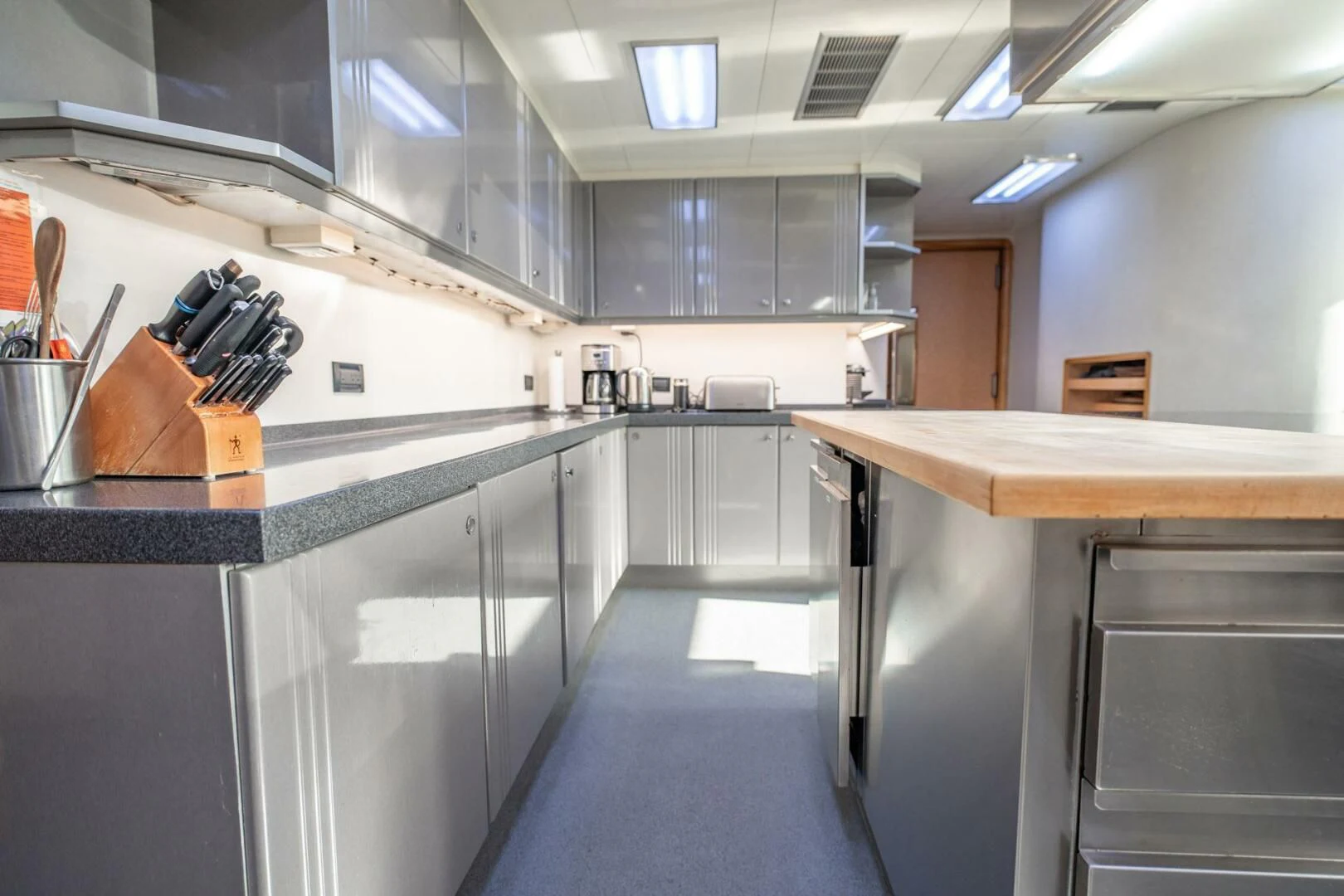 a kitchen with a large island aboard ISLAND HEIRESS Yacht for Charter