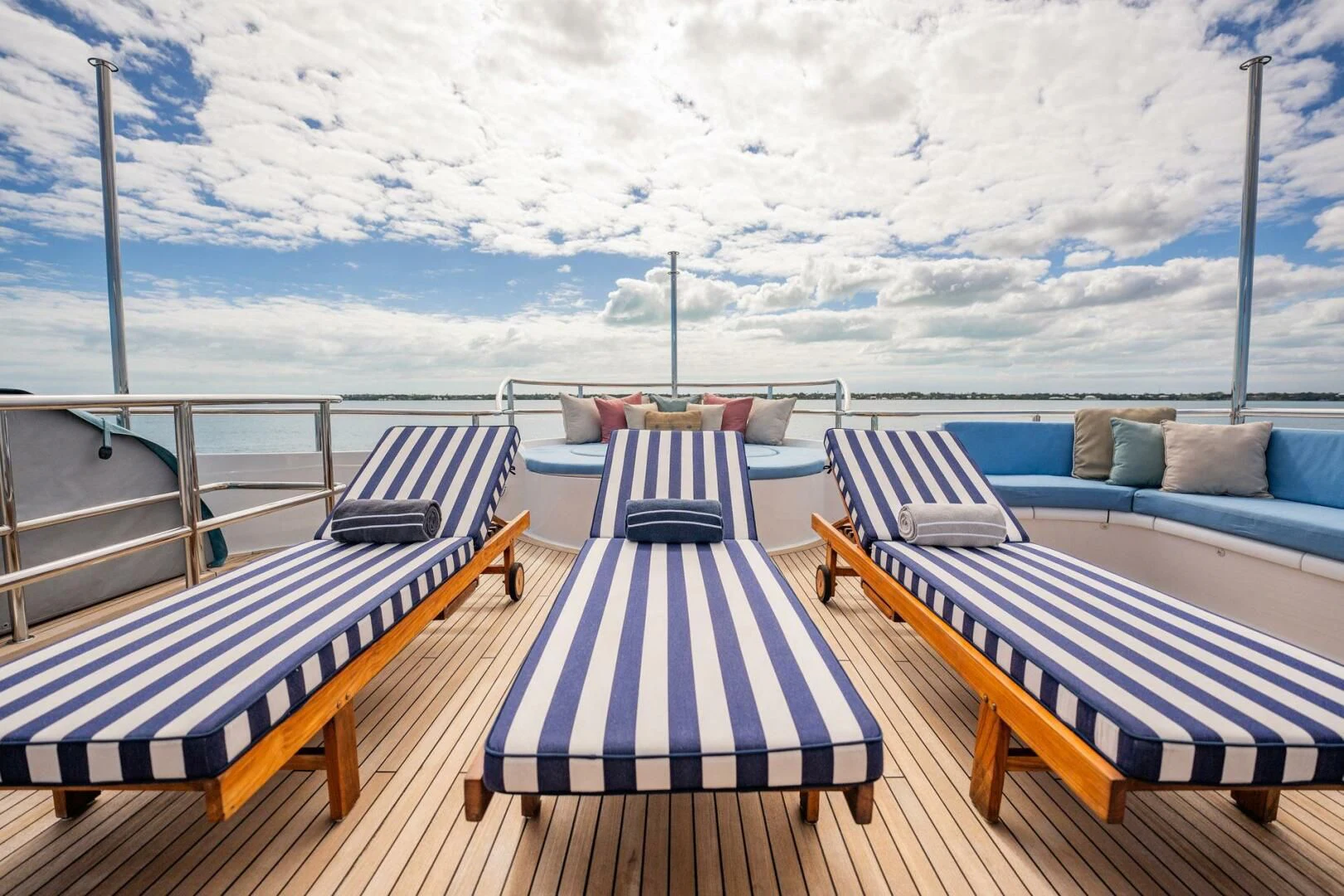 a deck with chairs and a table on it aboard ISLAND HEIRESS Yacht for Charter