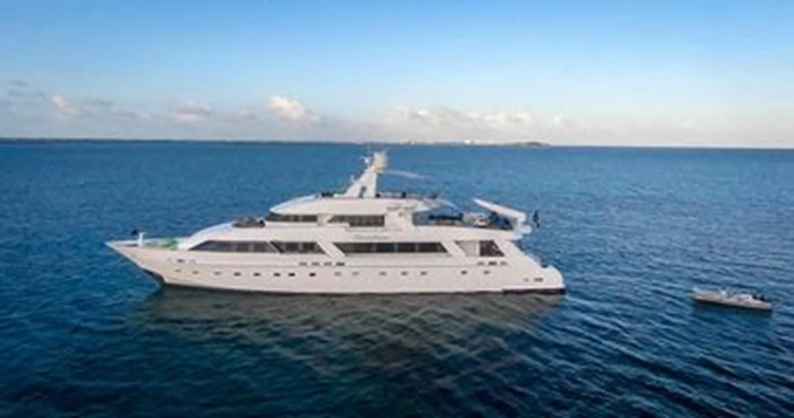 a large white boat in the water aboard ISLAND HEIRESS Yacht for Charter