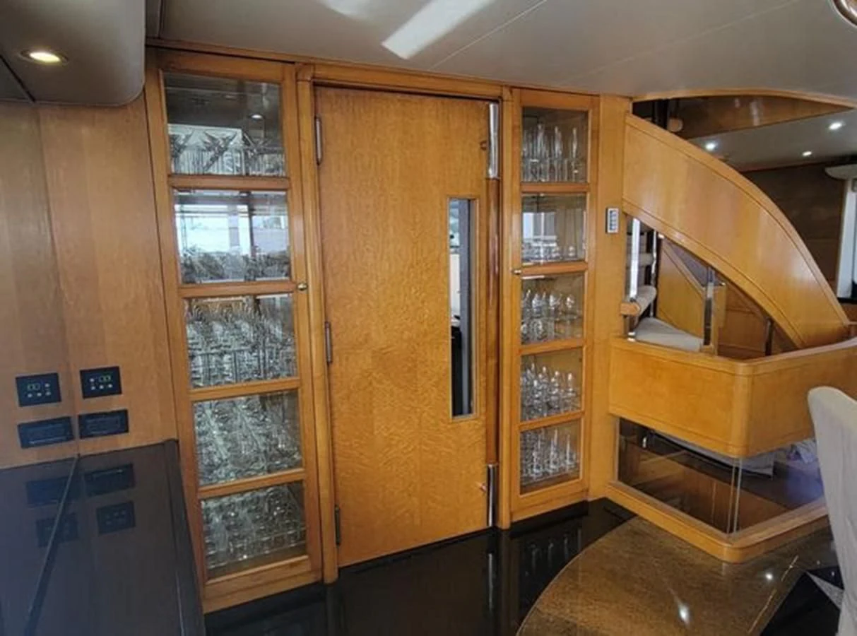 a room with a wood cabinet and shelves aboard ISLAND HEIRESS Yacht for Charter