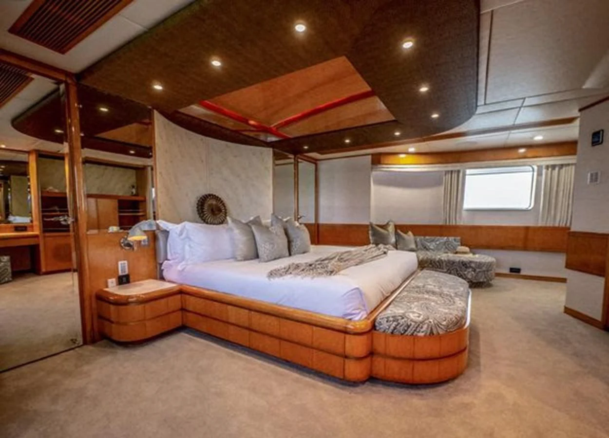 a bedroom with a bed and a wood floor aboard ISLAND HEIRESS Yacht for Charter