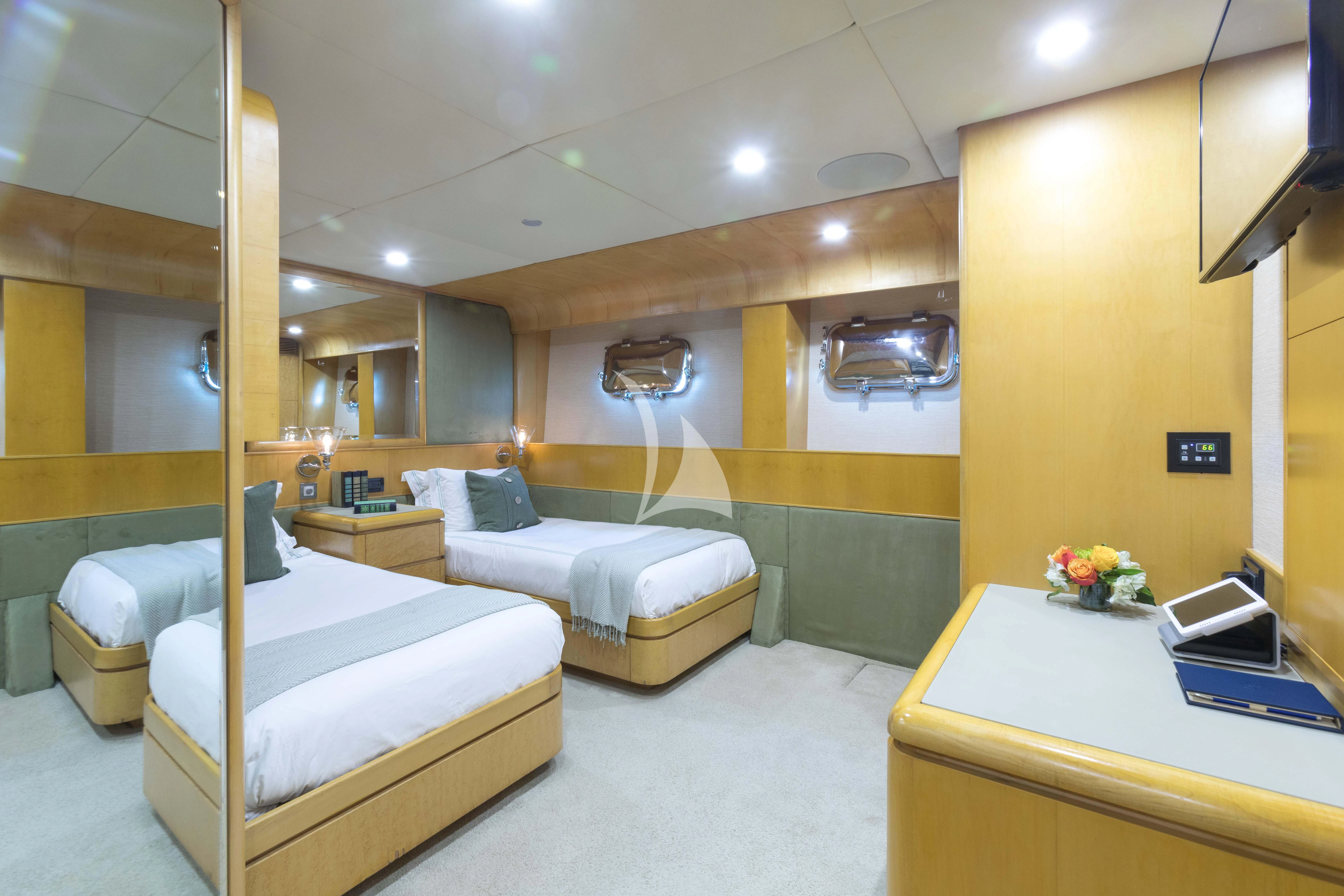 a room with a bed and a desk aboard ISLAND HEIRESS Yacht for Charter