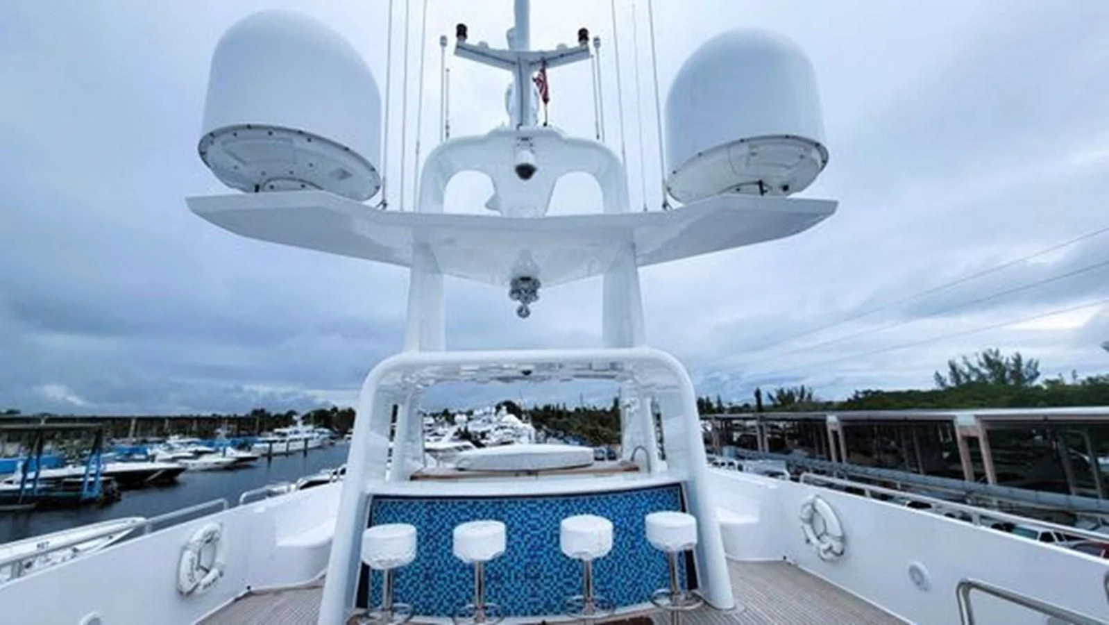 a white boat with a satellite dish on it aboard ISLAND HEIRESS Yacht for Charter