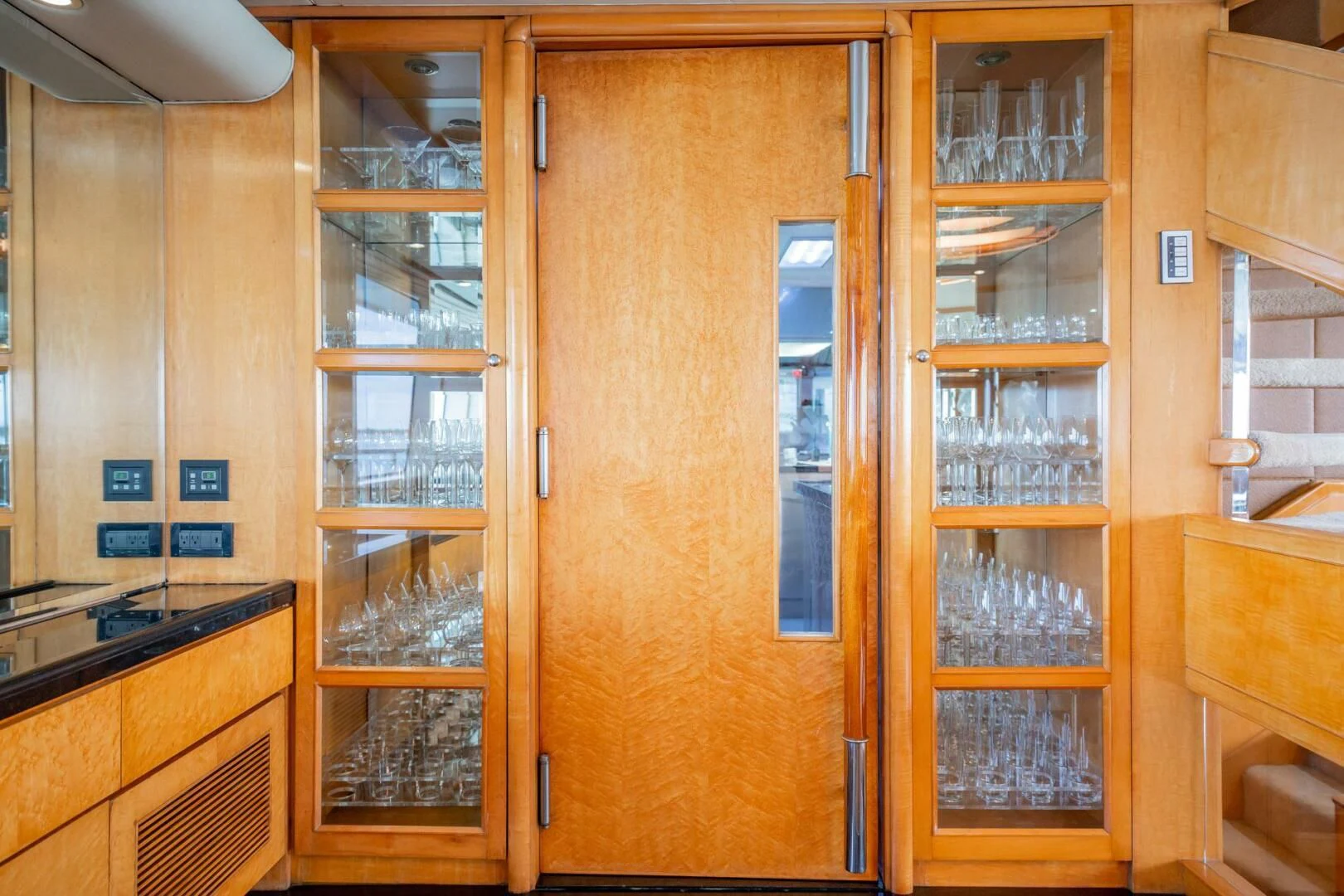 a wooden cabinet with glass doors aboard ISLAND HEIRESS Yacht for Charter