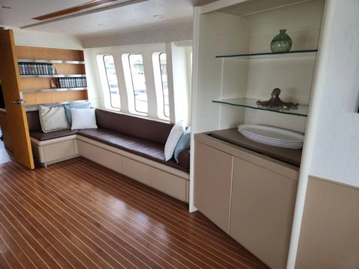a bedroom with a bed and a bookcase aboard ISLAND HEIRESS Yacht for Charter