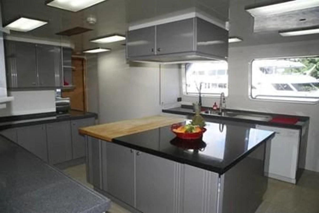 a kitchen with a bowl of fruit aboard ISLAND HEIRESS Yacht for Charter