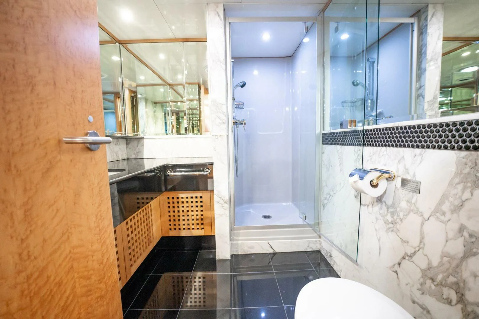 a bathroom with a glass shower aboard ISLAND HEIRESS Yacht for Charter