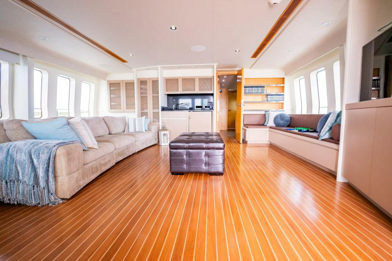 a large living room with a wood floor aboard ISLAND HEIRESS Yacht for Charter