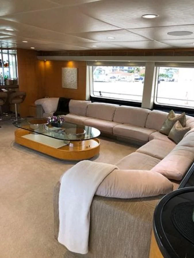 a living room with a couch and a coffee table aboard ISLAND HEIRESS Yacht for Charter
