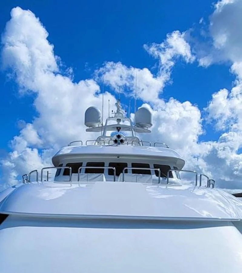 a white yacht on a blue sky aboard ISLAND HEIRESS Yacht for Charter