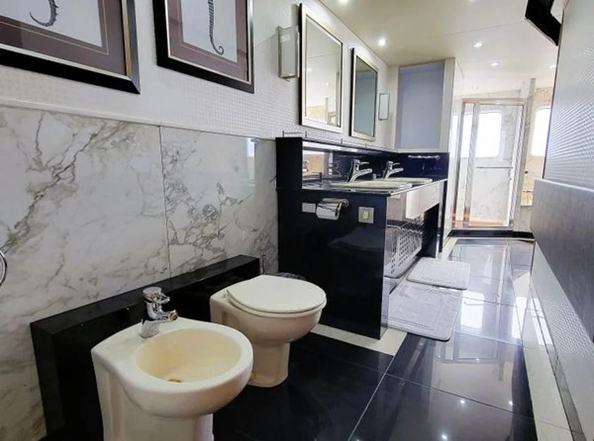 a bathroom with a tub sink and toilet aboard ISLAND HEIRESS Yacht for Charter