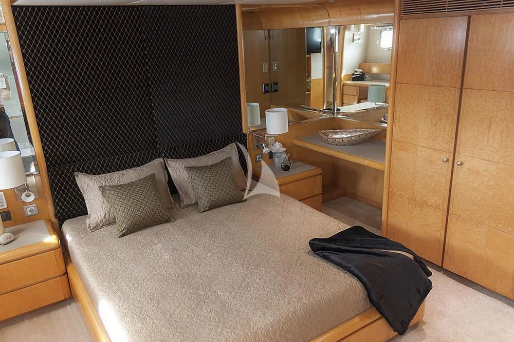 a bed with a black blanket aboard ISLAND HEIRESS Yacht for Charter