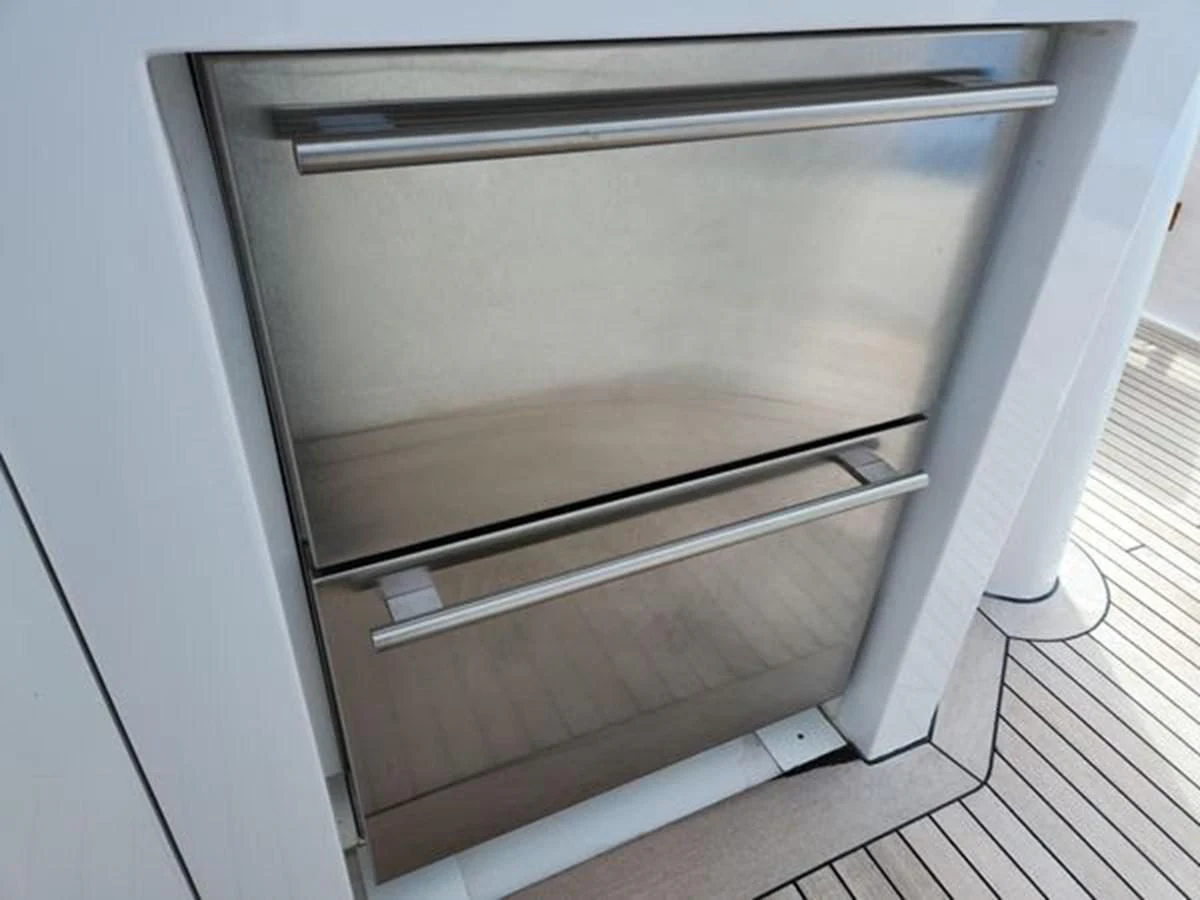 a white refrigerator in a kitchen aboard ISLAND HEIRESS Yacht for Charter
