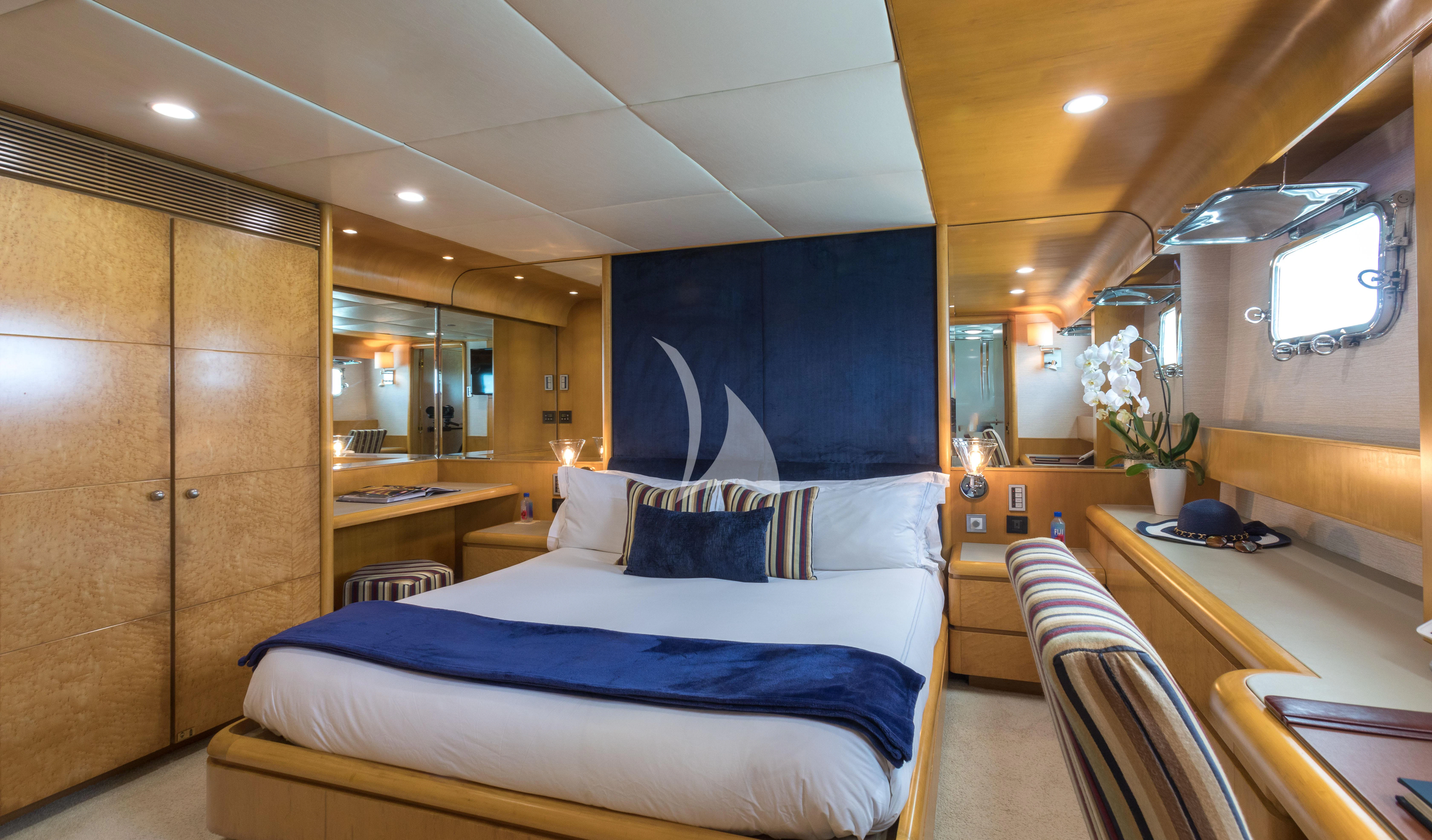 a room with a bed and a desk aboard ISLAND HEIRESS Yacht for Charter
