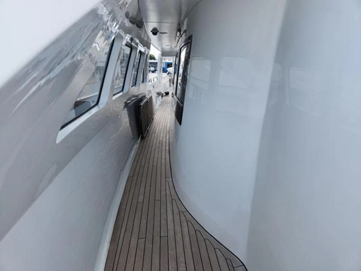 a long hallway with a row of computer screens aboard ISLAND HEIRESS Yacht for Charter