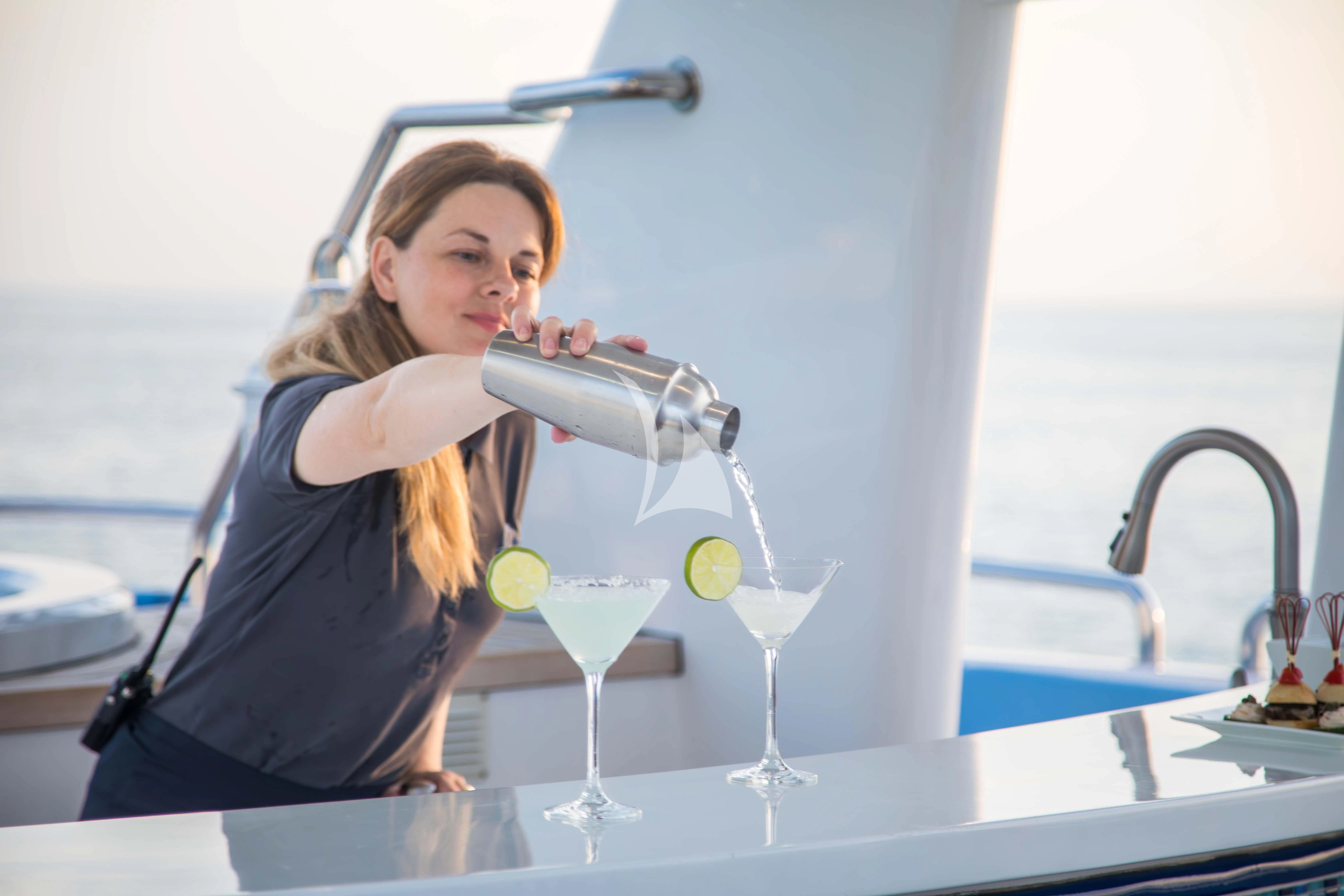 a person pouring a glass of wine aboard ISLAND HEIRESS Yacht for Charter