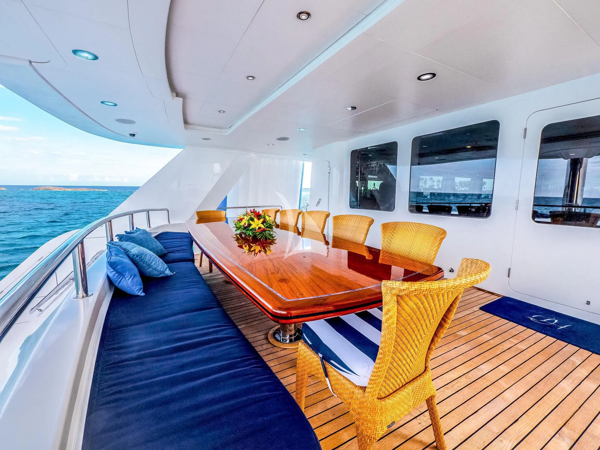 a large boat with a table and chairs on a deck aboard ISLAND HEIRESS Yacht for Charter