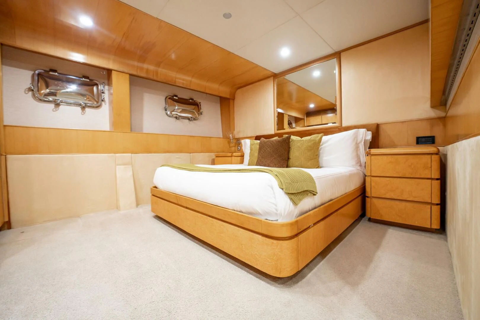 a room with a bed and a mirror aboard ISLAND HEIRESS Yacht for Charter