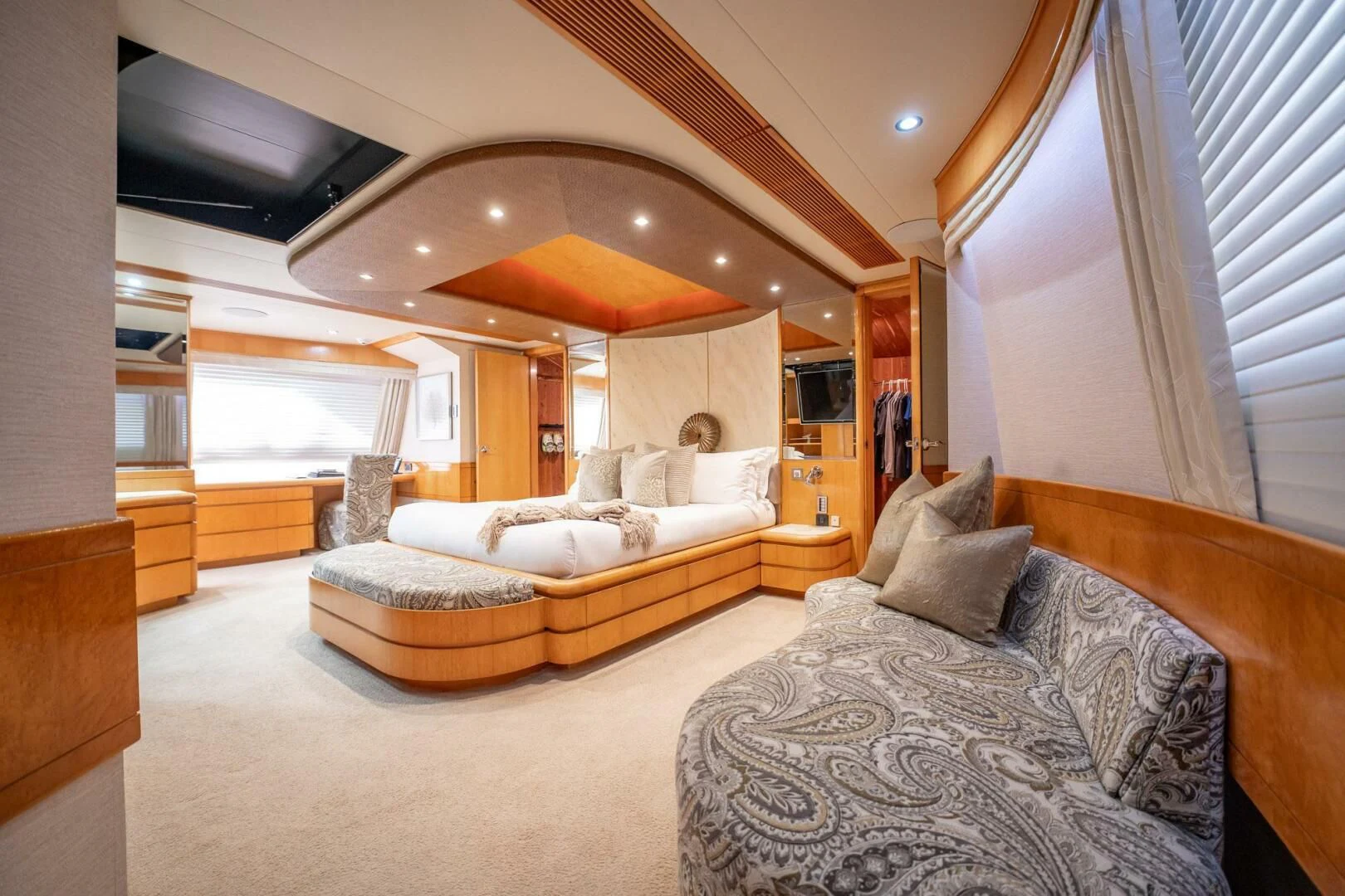 a large living room with a large bed and a large mirror aboard ISLAND HEIRESS Yacht for Charter