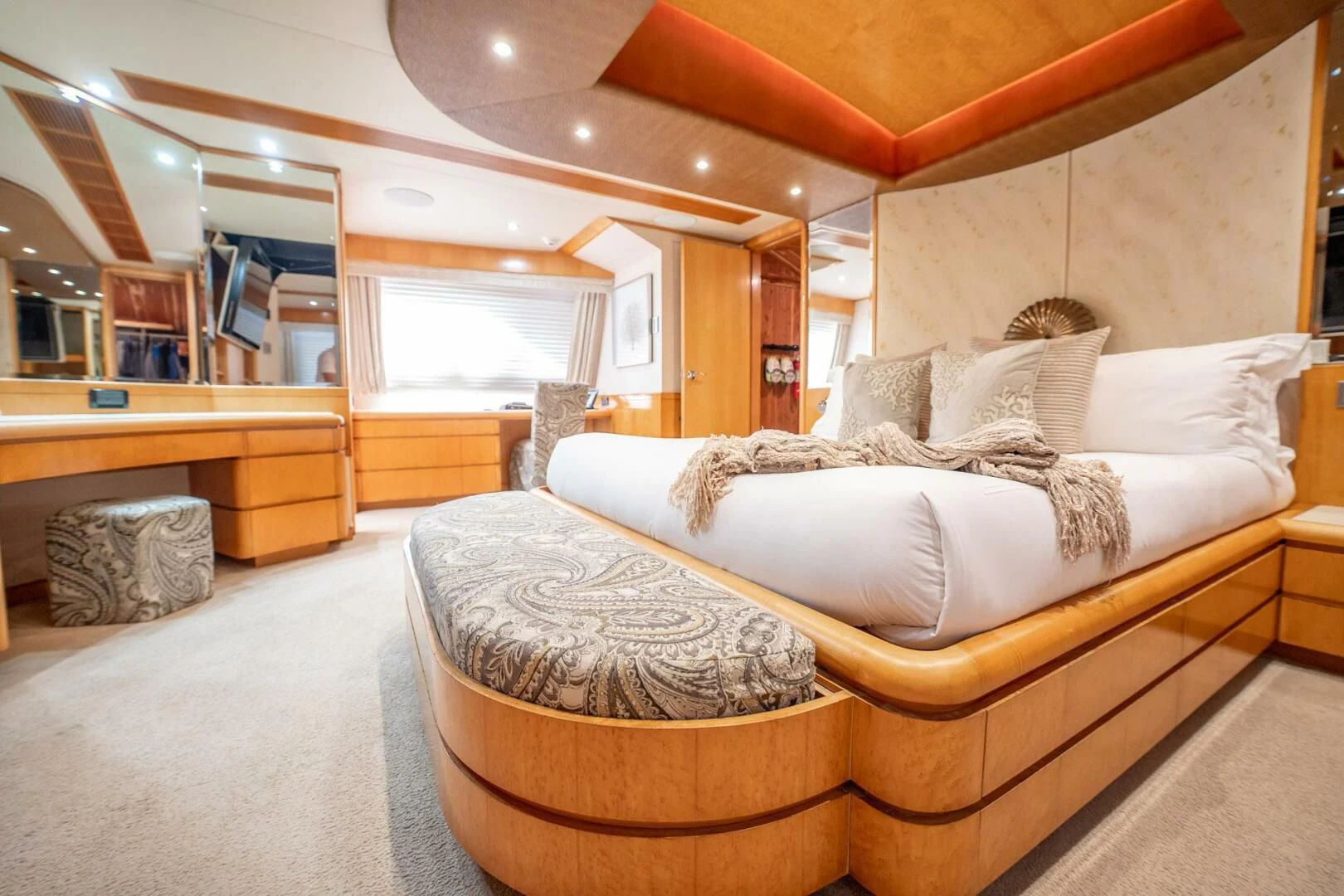 a bedroom with a bed and a desk aboard ISLAND HEIRESS Yacht for Charter