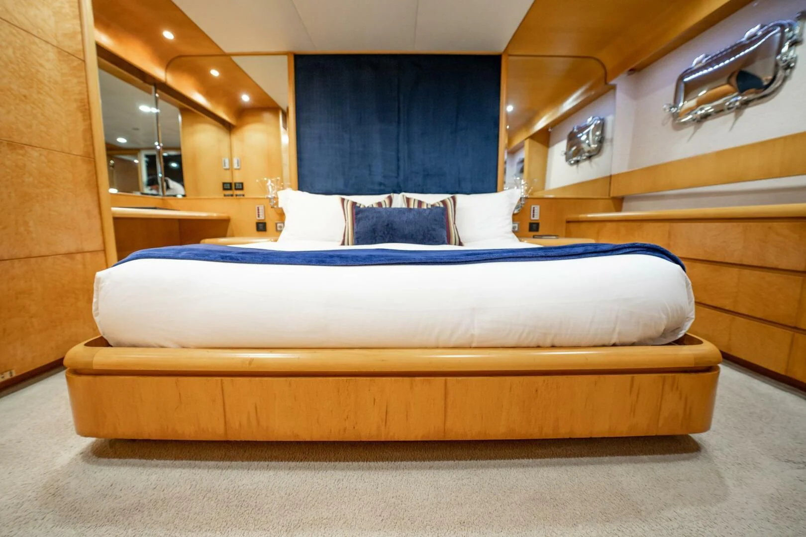 a bed with a blue sheet aboard ISLAND HEIRESS Yacht for Charter